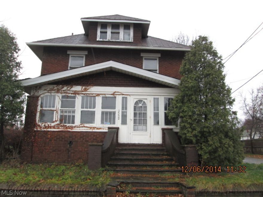 Large 2 story brick home with four bedrooms, enclosed porch & detached garage on a corner lot.