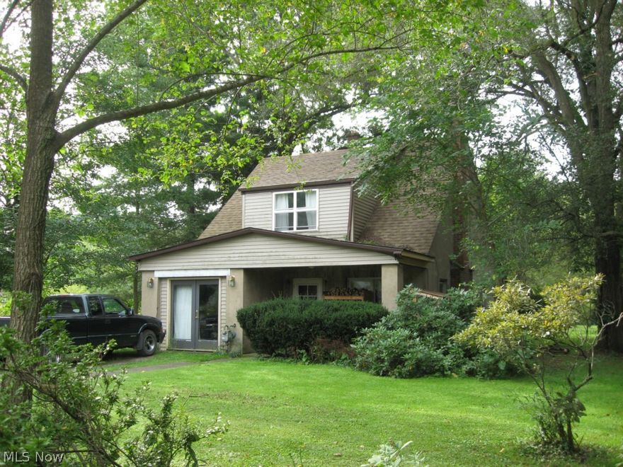 60x40 outbuilding has been used for car repair business.  Sale price included: residential home; four-car, detached garage; Quonset style 60x40 outbuilding.  Very private property, house and outbuilding tucked away on 6.5 acres, heavily wooded lot.  Outbuilding has 14' overhead door and 14" thick concrete floor designed to allow for driving semi tractor-trailers into building.  Quick access to Route 20, Ohio Turnpike and I-480.  Just minutes to mall.  No city tax, located in a Township. Security cameras do not stay.  Also zoned residential - See MLS 33652722