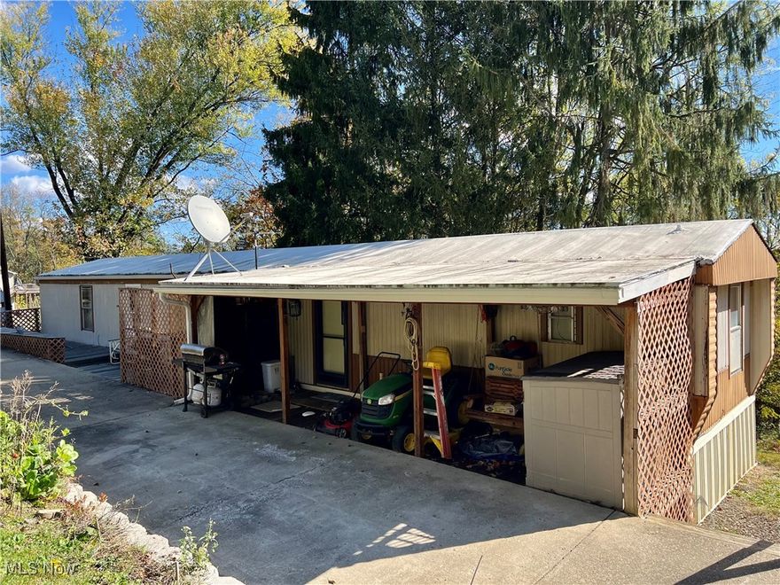 NEW PRICE!!
Tucked away for privacy this single wide mobile home situated on 1 acre offers one level simple living with 3 bedrooms and 2 full bathrooms. The equipped eat in kitchen features plenty of cabinetry and is open to the living room with large wall mounted television to enjoy friends and family while preparing meals. Plenty of parking on the long driveway with new retaining wall and detached shed for extra storage. Updated electric service, hot water tank, some new windows and priced to sell at $39,500.  Don't wait to call.