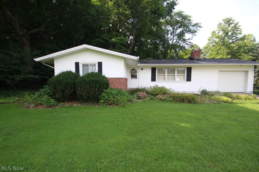 Three bedroom Ranch home in Kirtland on a beautiful 1 acre setting near the Chapin Forest Reservation. 
Large living room is featured with hardwood floors, gas fireplace and adjacent dining room with access to an enclosed deck. Full basement offers possibility of additional living space. Attached garage with newer door and opener and loads of built in cabinets and ½ bath. Some updates include the driveway, hot water tank, gutter guards, roof and some windows. Basement has been waterproofed and offers a lifetime warranty. Additional 1 acre lot available as a package but will not be sold separately. Call agent for details.
