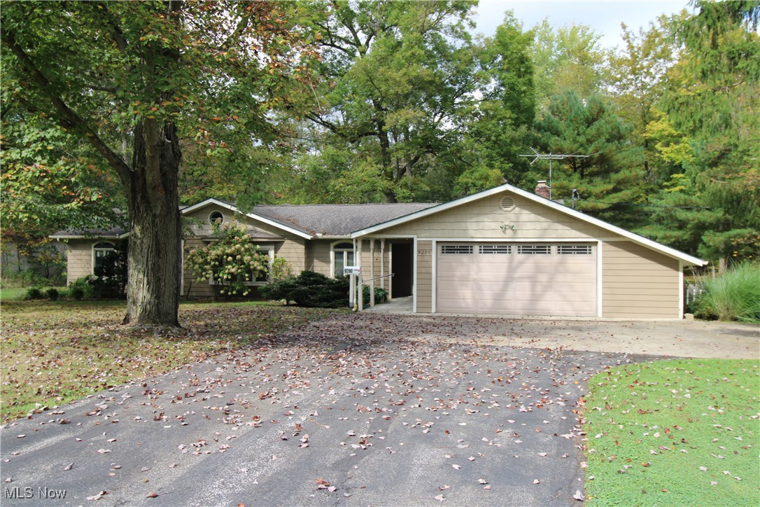 Who doesn't love a charming 1959 ranch nestled on 1.5 lush, wooded acres in the heart of Bainbridge Township, Kenston Schools? This 3-bedroom, 1.5-bath home offers a rare blend of mid-century character and modern comfort. The interior is waiting for your personal touches and decorating ideas. The vaulted ceiling in the family room addition with its prominent wood burning fireplace and mantle could be your spot to decompress after a hard day's work. Freshly painted in 2024, the exterior is well maintained. It has a quaint front porch area, but the peaceful views from the enclosed rear porch complete with a hot tub and wood burner, are a site to be seen. Step out onto the deck that runs the length of the enclosed porch to entertain or be surrounded by nature. The property features a heated and air conditioned 32x21 outbuilding that was constructed with a concrete floor with 2" high density foam and 4" of stone for added warmth, a 220 line, a garage bay door, and a porch with lean-to —perfect for a workshop, studio, mancave, she-shed, or extra storage—plus a 10x10 shed for added convenience for your gardening tools etc. A whole-home gas generator is the "cherry on top" and ensures peace of mind year-round. Don’t miss this private retreat just minutes from downtown Chagrin Falls and the many conveniences it offers!