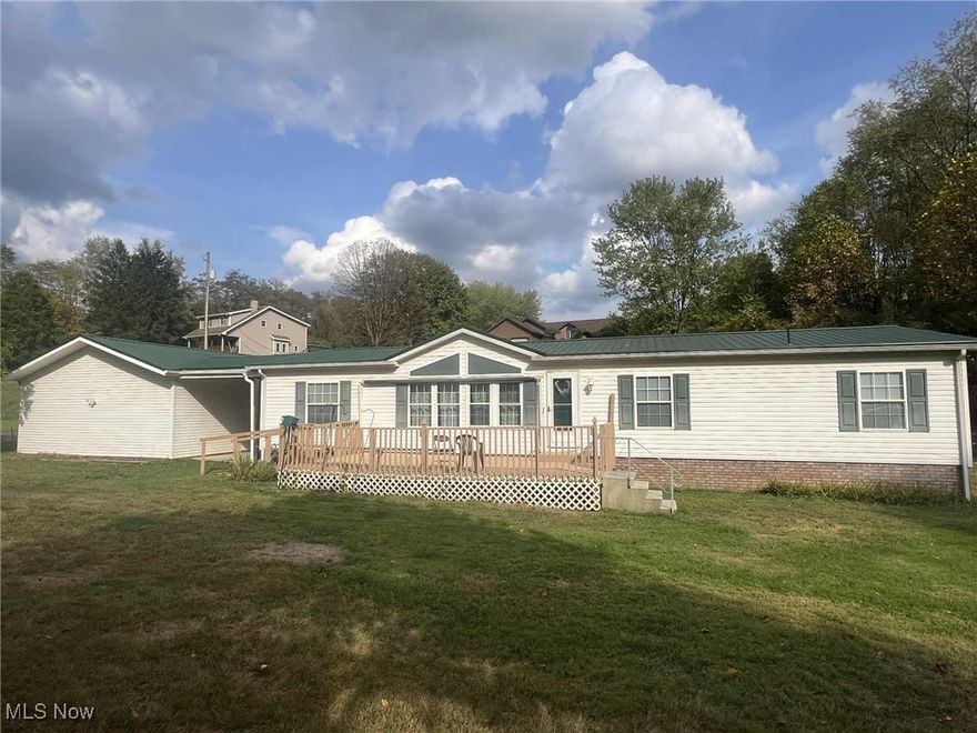 Discover the perfect blend of comfort, space, and functionality in this charming 3-bedroom, 2-bath ranch-style manufactured home, ideally situated on over 1.5 acres at the edge of town. Step inside to find an inviting and open floor plan with vaulted ceilings and two separate living areas offering plenty of space to relax and entertain. The spacious kitchen leads to an attached dining area which opens to the living areas. This home features three bedrooms, including a master bedroom complete with its own full bath. A covered breezeway conveniently connects the house to an oversized two-car garage which also includes loft for extra storage. Accessibility is a key feature of this home with ramps leading to both the front deck and back door for easy entry. Outside, the flat, peaceful yard offers privacy, open space, and plenty of room for gardening, recreation, or even future expansion. This property offers the best of country-style living with the convenience of nearby town amenities. Don’t miss the opportunity to make it yours!