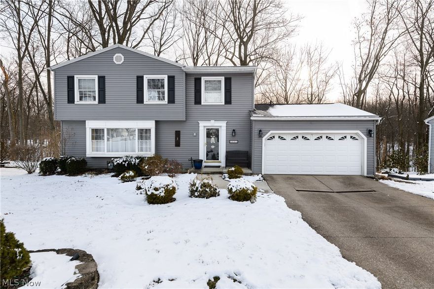 Welcome home!  This 5 bedroom colonial with great curb appeal features 2 full baths, 2 half baths, and nearly 2,000 sq ft (above grade only).  The home also boasts a partially finished walk-out basement with rec room and bath, adding over 500 sq ft of additional living space.  Enter the foyer and you are greeted by both the spacious formal living room with large bay window or the cozy family room with stunning views of Sand Run Park from the floor-to-ceiling windows/door leading to the deck.  The 1st floor also boasts a formal dining room adjacent to the kitchen with granite counters, as well as a half bath off of the foyer for convenience.  There are hardwood floors and crown molding throughout the formal living room, dining room, and family room.  All 5 bedrooms, including a full bath off of the hallway and Jack-n-Jill bath between the bedrooms, are upstairs.  Downstairs you will find plenty of unfinished storage, a large rec room with wood paneling and barn door leading to a finishe