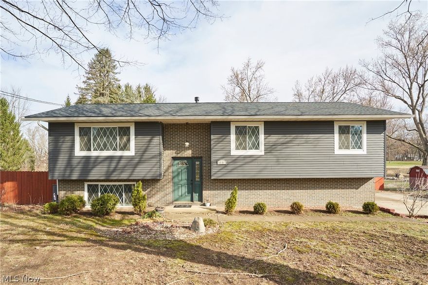 Welcome to this beautifully updated 3-bedroom, 2.5-bath home set on a .53 acre landscaped lot. The exterior features new siding, a new roof, and updated windows for added peace of mind. Inside, enjoy a bright open layout where the living room, dining room, and kitchen flow seamlessly together—perfect for everyday living and entertaining. The kitchen offers granite countertops, a stone sink, all appliances included, and a distinctive live-edge bar. Sliding doors lead to an impressive two-tier deck overlooking the spacious backyard with a storage shed. The home features generously sized bedrooms with new flooring, including a primary suite with a private bath and luxurious two-person shower. The main bath has been beautifully remodeled and includes a jetted tub. The walkout lower level provides a cozy living space with a gas fireplace, laundry area, and access to the attached garage. Recent upgrades include a tankless hot water heater, covered patio, stamped concrete patio and walkway, new upper deck with vinyl railing, and a fully fenced backyard with multiple entry points.