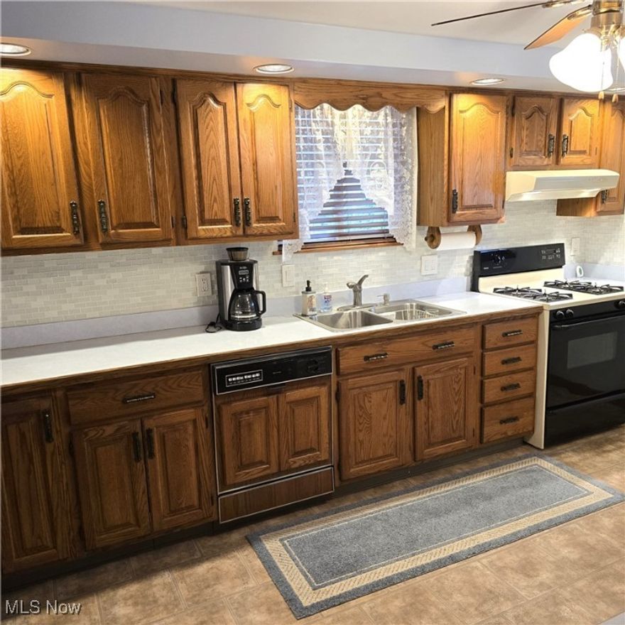 Be first or be sorry! Longtime owner took pride here! Updated kitchen with plenty of oak cabinets. Built-in hutch in the dining area. Four season sun room with wrap around deck. Main bathroom updated approximately two years ago. Basement has recreation room with stone fireplace, dry bar, full bathroom, bonus room, laundry room, mechanical room and glass block windows. Oversized two car garage with workshop and shelves. Front covered porch with natural stone. Includes one year home warranty!