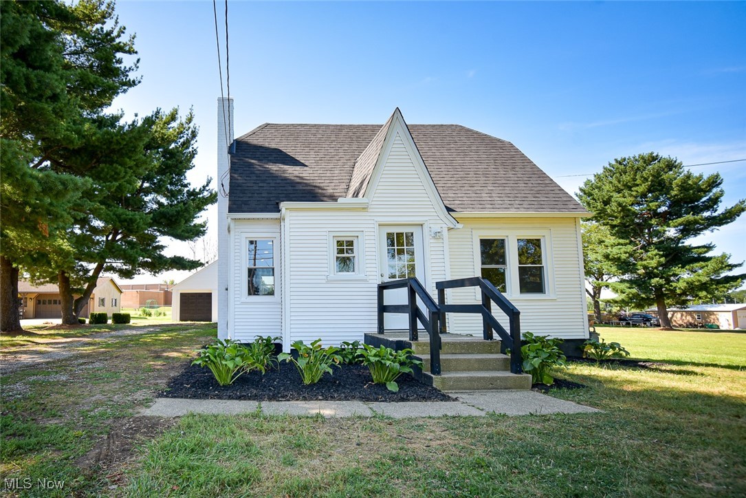 This beautifully renovated Cape Cod offers the perfect blend of charm and functionality, featuring four bedrooms, two full bathrooms, and a detached two-car garage, all situated on a full acre. Lovely landscaping welcomes you to the front entry, where a foyer with a coat closet sets the tone for the thoughtfully designed interior. Step into the bright, open-concept living area where the living room and kitchen offer an airy, spacious feel. The kitchen is a showstopper, featuring a vaulted ceiling, quartz countertops, brand-new stainless steel appliances, an island with a breakfast bar, and ample cabinet and counter space. Easily access the backyard and garage through the rear door off the kitchen. Part of a brand-new 2025 addition that also includes the custom kitchen, the main floor boasts a private primary bedroom with a vaulted ceiling and direct access to the new stunning full bath, complete with a walk-in shower. A second bedroom rounds out the first floor. Upstairs, you’ll find two nicely sized bedrooms and a second updated full bath. The clean basement offers tons of storage space or is ready for your finishing touches - whether you envision a home gym, rec room, or additional living space. The backyard offers plenty of room to play, relax, or entertain and includes a few charming fruit trees. Additional major updates include a new roof, gutters, all new windows, a sump pump, A/C, and updated plumbing and electrical in 2025. With its upgrades, open layout, and serene outdoor space, this move-in-ready home is a must-see!