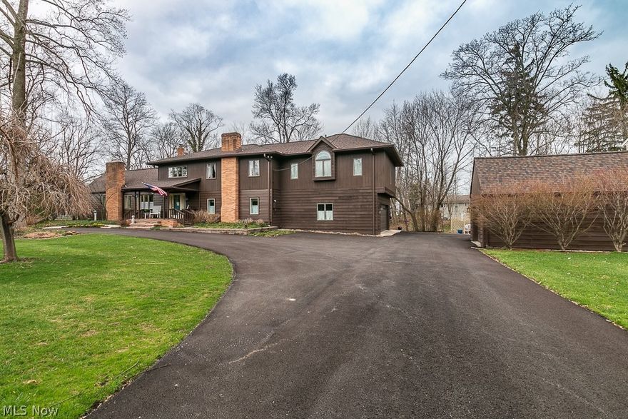 Welcome to your very own modern farm house with a contemporary flare.   Open kitchen/great room, complete w a farm house sink.  Many wonderful updates & improvements.  New Roof on the house and garage, new eves and gutter system 2018, converted to city sewer 2011, new asphalt driveway 2021, Exterior House painted 2018, Interior Home painted 2019, Tile Flooring in Laundry/Bath 2016, New baseboards in most of the home in 2016, Front Porch Nature Stone 2019, new front retaining wall 2021.   220 outlets in both attached garage and detached garage...complete with loft area.   Large deck runs across the back of the home and a deck is available off the master bedroom.  Family room has a gas fireplace a discrete powder room and a large loft .   Kitchen has been redone to expose the beautiful original ceiling beams.   The home's interior has been painted with an Oil paint for a lush finish. 5th Bedroom used as den