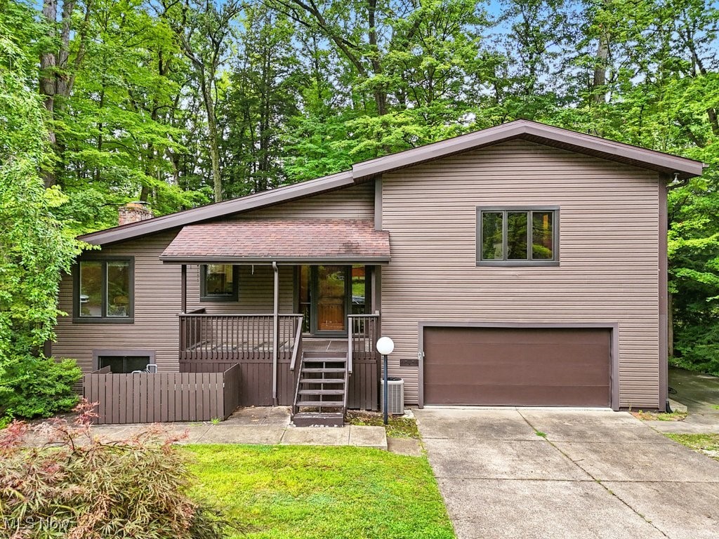Spacious split-level home on a cul-de-sac with endless potential. The home offers nearly 2400 square feet of living space. Step inside to the large great room and bright eat in kitchen. This home features some hardwood floors, newer vinyl siding and not one, but two three season rooms. The walkout lower level includes a cozy family room with fireplace, as well as two bedrooms and a full bath. the second level includes two bedrooms including the primary bedroom and one full shared bath with double sinks. The two-car attached garage features nature stone flooring and storage cabinets. Set on a partially fenced wooded lot this property adds privacy and room to unwind. There is a whole house generator for your peace of mind. All the appliances will stay. This is a perfect opportunity to add your personal touch and create your dream home.