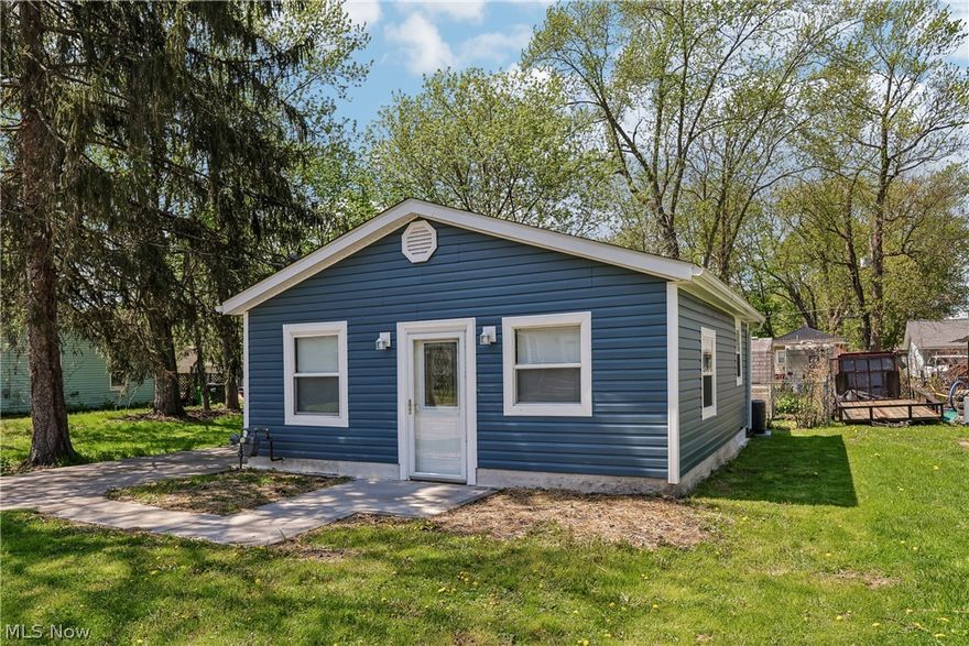 Adorable, fully renovated 2-bedroom, 1-bath showstopper cottage in Lakemore just moments from Springfield Lake. Taken down to the studs and rebuilt, this home offers the feel of new construction throughout. Updates include new roof, siding, windows, electrical, plumbing, drywall, lighting, and mechanicals including hot water tank.

The standout kitchen is a true focal point, featuring Granite countertops, tile backsplash, and a thoughtfully designed layout with upscale finishes. The full bath is beautifully updated with a tiled tub/shower surround and glass doors.

LVT flooring runs throughout the main living areas with carpet in the bedrooms. Recessed lighting with dimmable features adds comfort and flexibility. All appliances convey, including stackable washer and dryer.

Concrete driveway and low-maintenance exterior complete this move-in ready home.
