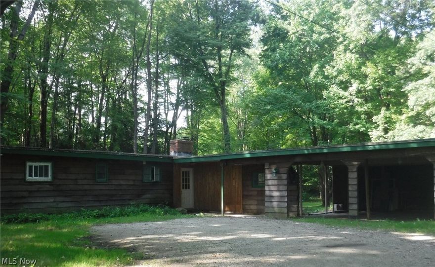 The living room has large window overlooking the wooded yard and patio. There is a 14x9 porch that can be screened in. Galley style kitchen and Separate laundry room. Large double coat closet. Furnace and hot water heater were newer when owner bought home in 2009. Two car carport can be converted into a garage. The yard is over 2 acres! Home needs some work but has a lot of potential!!