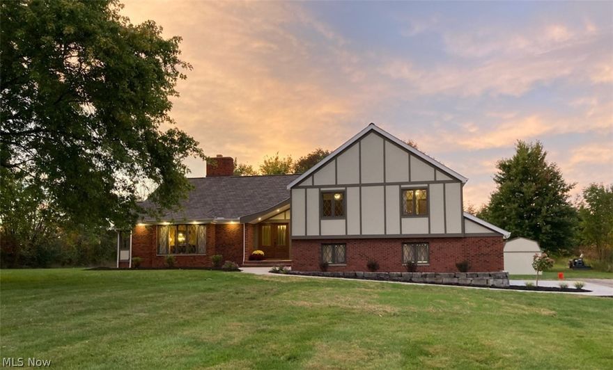 Grand Tudor with the interior and exterior updated.  This house has a gourmet kitchen with granite counters and ample cabinets. Elegant living room w fireplace and oak floors that continue into the dining room.  Off the dining room, you can relax in the 4 season room with peaceful views of nature.  Downstairs you'll find the family room complete with bar and newly stained concrete flooring and full bath.  Upstairs has a spacious owner's suite with oversized sliding doors that lead to a new Timbertech terrace to enjoy coffee and natural surroundings.  Also on the second floor are 3 other spacious bedrooms a full bath and a half bath for guests.  Up one more flight of stairs to a 34' X 16' room that can be a bedroom, playroom or office.  This property is zoned residential and commercial so you can run a Limited Manufacturing business on this property with 8 acres.  The exterior of the house has new this year roof, gutters and James Hardy siding, exterior doors and new asphalt for the dri