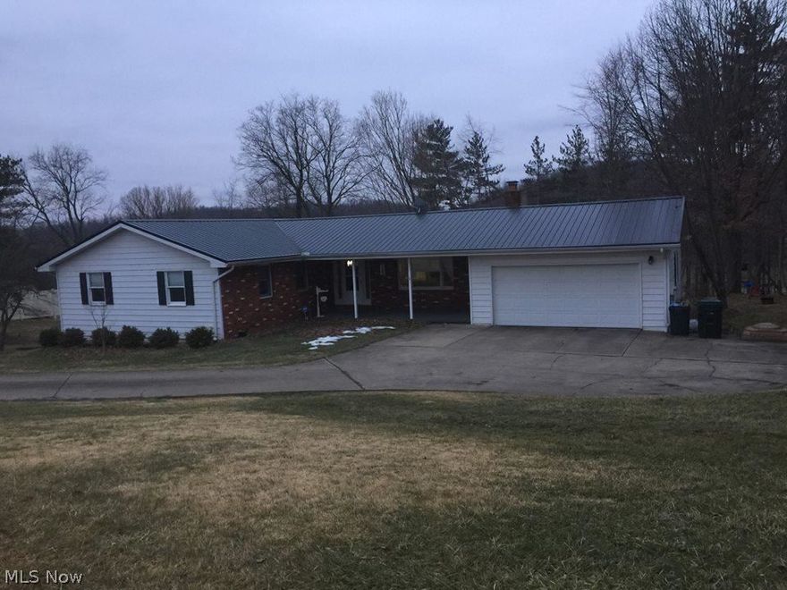 LOCATION, LOCATION, LOCATION! Numerous updates in this 3 bedroom, 2 bath ranch home with new metal roof, 2 fireplaces, finished rec room, stainless appliances, and new deck with roof which is perfect for outdoor entertaining.  4th bedroom could be easily added in basement den.  Plumbing in closet on first floor which could easily be converted to first floor laundry.  Railing on steps to deck to be added once weather permits. Home Warranty!