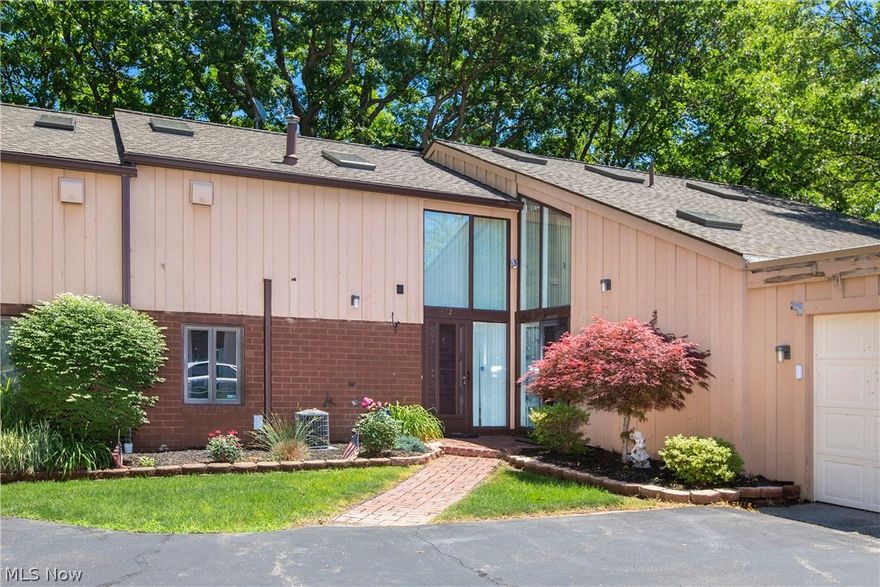 Prepare to be Moved!...Into this unique Lorain condo. You’ll feel like the rest of the world is a million miles away when you come home to carefree living in a park-like setting! You’ll enter into the foyer with open stairs to the second floor, a convenient half bath and eat-in galley kitchen. But what comes next will simply take your breath away. As you move into the living room, a two-story “greenhouse” wall of windows looks out over Beaver Creek and Fox Creek Golf Course, and the Master Bedroom enjoys that same view from the second floor balcony. So day or night, spring blooms or fabulous fall, you’ll enjoy your very own private nature show every day of the year. The living room also offers an impressive fireplace, while two sets of sliding doors complement the window wall and provide easy access to the shady deck. Upstairs, the Master Suite is roomy enough for a lounging, sitting or even an office area. Built in closets, shelves and drawers offer tons of storage space and combined