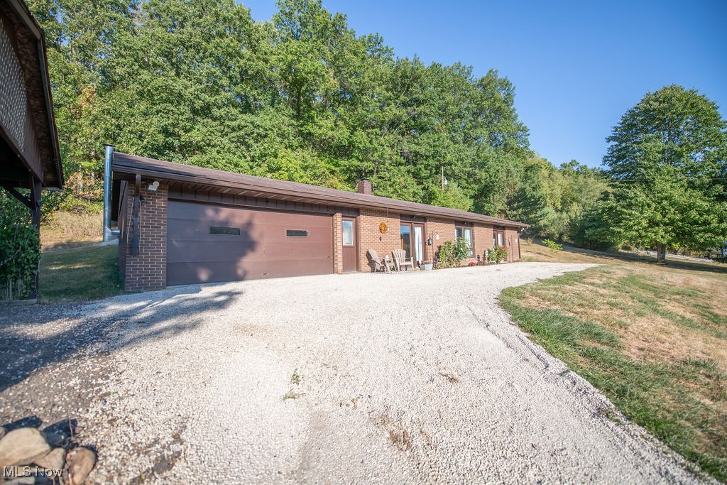 Charming 2-bedroom brick ranch home nestled in a peaceful, wooded setting. This desirable property features easy access to outdoor recreation, with Atwood Lake Marina East located less than a half-mile away, providing convenient opportunities for boating, fishing, and enjoying the lake's amenities. This home offers a desirable open floor plan, creating an inviting living space. The thoughtful design features the laundry room, 2 bedrooms and bathroom conveniently situated just off the large kitchen, offering both practicality and ease of access for everyday living. Don't miss the opportunity to experience the peaceful setting and the perfect layout this property has to offer. Call today for a private viewing of this home.