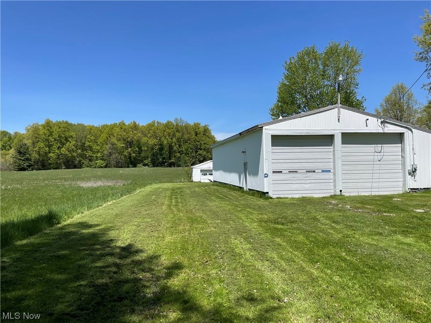 Nearly 9 acres in Edinburg Township, this property has so much to offer! The main feature is a 2640 sqft (60x44) building with three 14ft doors, electric, air compressor, oil heating system, and a designated office area with full bath.  The entire building has spray insulation, commercial high wattage lighting, ceiling fans, and a cement floor. There is an additional outbuilding with electric and lean to, and two corn cribs.  The front of the property is level and cleared, while a good portion of the back is wooded. Come check out 7117 Clark Road today!