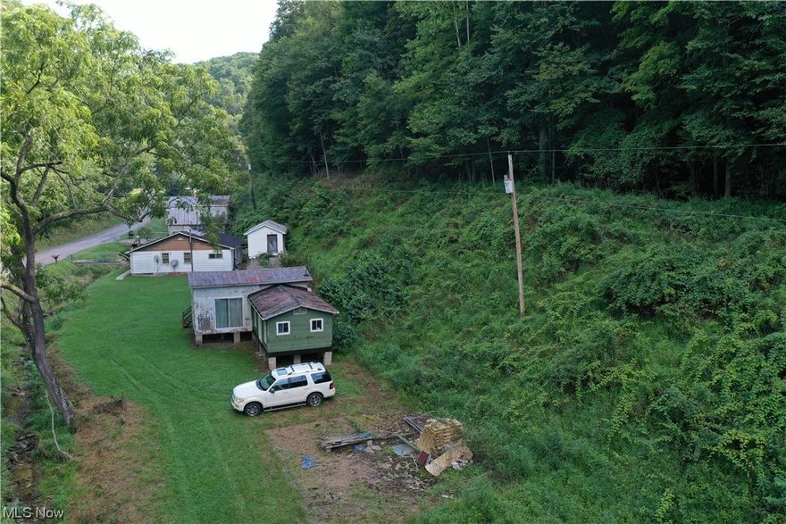 Discover your slice of Calhoun County, WV – 10.91 acres of pure potential. Wooded hillsides frame the scene, while a perennial creek adds serenity. A flat spot by the creek welcomes your ideas – a home, a cabin, or a camper. Electricity is ready, and no building codes mean your dreams have free rein. Rainwater harvesting and off-grid living are embraced. Access is easy, and minimal cleanup readies this canvas for your vision. Embrace the beauty of nature and craft a life that's authentically yours on this versatile acreage.