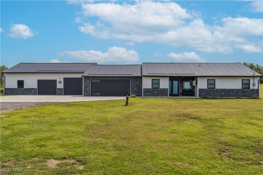 Welcome to this exceptional newly built custom estate, nestled on nearly 25 acres of breathtaking countryside. This gem features a sprawling open-concept design with Ferrari black quartz countertops, brand new appliances, and a seamless indoor-outdoor flow perfect for both entertaining and everyday living. The kitchen opens to a walk-around patio and an outdoor kitchen with granite countertops, ideal for enjoying quiet evenings or hosting under the stars. No detail was spared—from the radiant heated floors throughout the home and all garages to the energy-efficient tankless hot water system. Car lovers will be in awe of the attached 7-car garage, providing ample space for collections, workshops, or recreational vehicles. With scenic views in every direction, unmatched privacy, and luxury finishes throughout, this property is a rare opportunity to own a one-of-a-kind residence that blends elegance, comfort, and functionality.