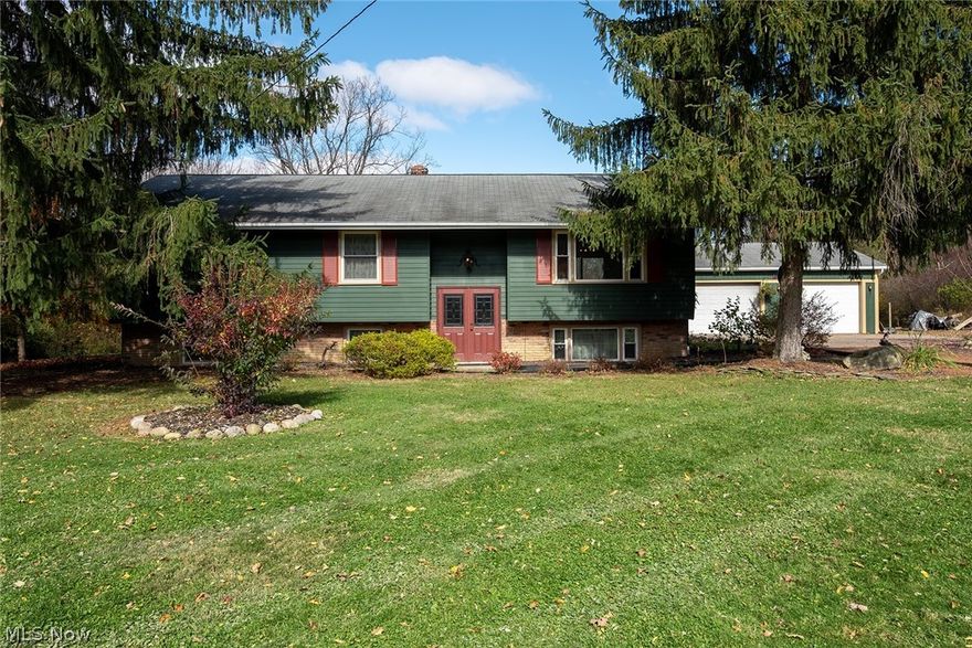 Welcome to this well-cared-for 3-bed, 2-bath bi-level property with loads of rustic charm on a beautiful 1.6 acres near The West Woods. Enter through the newer, double front doors and head up the stairs to the main living area with cozy sitting room before moving into the bright and spacious eat-in kitchen. Featuring dual access to the home's newer back deck, plenty of cabinet and counter space for all of your food-prepping needs, and a stylish linoleum floor for easy clean-up, this kitchen is sure to please any entertainer. Finishing off the upstairs are 3, well-sized bedrooms and a beautiful full bath with decorative tile surround and wood-look flooring. Moving downstairs, the home offers a perfect opportunity for an in-law suite or rental potential with another full bath, a sitting area with wood-burning fireplace, and a room that could function as a 4th bedroom. The basement area is equipped with a kitchenette and includes a double sink and 2nd stove along with the home's washer an