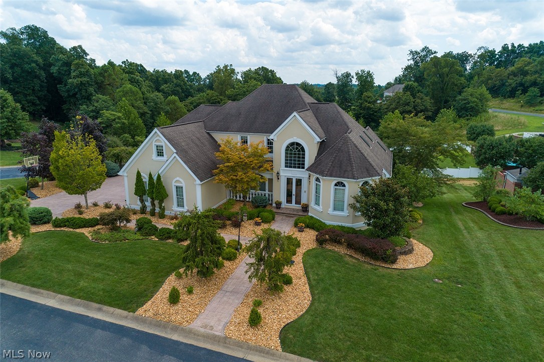 LUXURY REDEFINED.........This spectacular home is located in the gated Wyndemere subdivision. Rich in architectural detailing and custom finishes that include stunning Schonbek crystal lighting, granite and hardwood flooring, custom entry doors and extensive trim package. Two story colonnade Grand entry leads to large open space that is defined by volume ceilings and oversized windows that bring an abundance of natural light. The perfect home for entertaining features a banquette size dining room, gourmet style kitchen with breakfast bay that opens to raised terrace and two story fireside great room. First floor 21x16 owners en suite with sitting room and luxurious bath. An expansive lower level with fifth bedroom and fourth full bath, complete home theater system media room, exercise room, family room with wet bar and all season sun room. The mechanical system includes water softener, tank-less hot water heater, dual HVAC, audio, central vac, intercom and security systems. Sited on landscaped irrigated grounds, in ground 32x16 pool, three car side loaded garages and well planned storage. The protection of a TWO YEAR HOME WARRANTY. This home is an opportunity for the discerning buyer who appreciates QUALITY and STYLE.