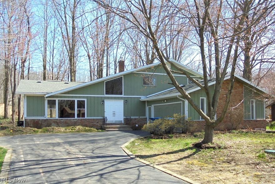 Dramatic and Spacious 4-Bedroom, 2-1/2 Bath Split-Level on a quiet, wooded, secluded street.  All New and Freshly Painted, with beautiful Wood Floors in Living Room, Dining Room, and Eat-In Kitchen.  Brand New Never-Used Stainless Appliances.  Granite Counter Tops in Kitchen and all 3 Bathrooms.  Ceramic Tile and New Plumbing and Lighting Fixtures throughout.  Brand New Carpeting in all 4 Bedrooms and New Ceiling Fans in Upstairs Bedrooms.  Large Newly Carpeted Family Room with Gas Log Fireplace.  Grand Foyer with double door entry.  Screened Rear Deck with Skylights and Ceiling Fan.  Large Wooded Backyard with Storage Shed.  Four levels including a large Basement.