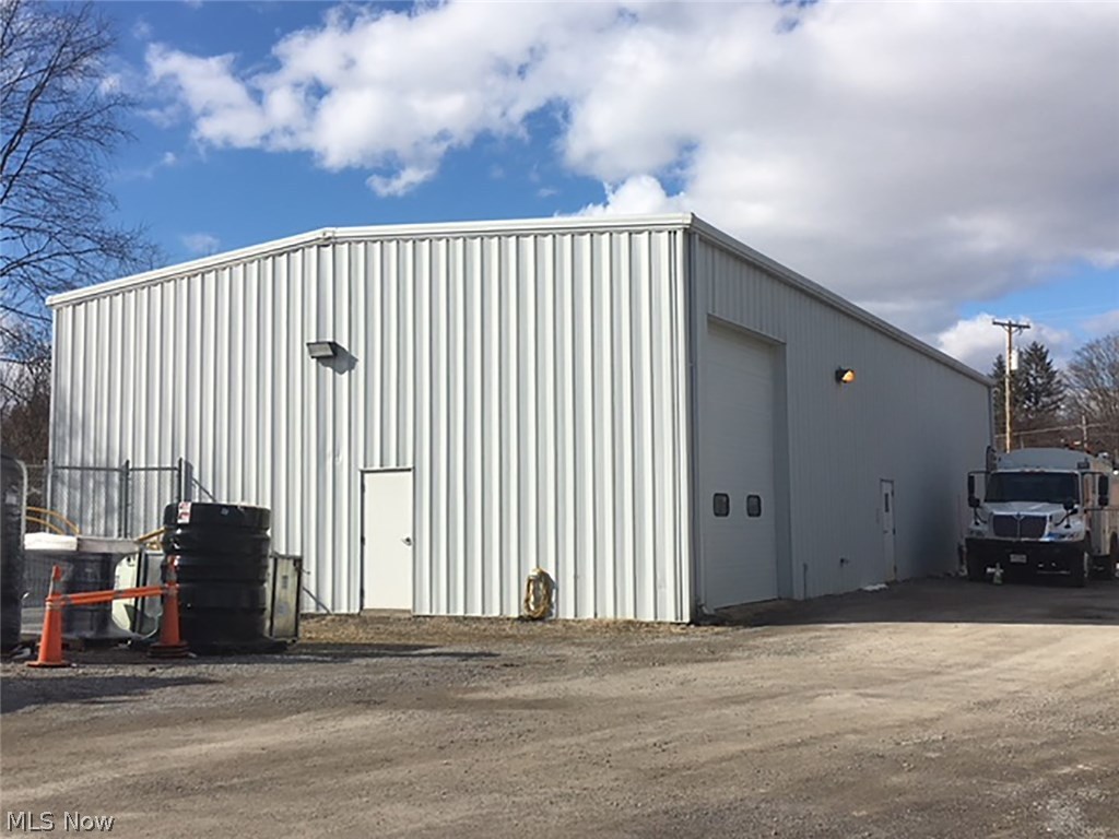 .786 acres - 3,200 sq. ft. 40x80 steel frame and truss building - 3 large roll up doors - High ceilings - City utilities - Excellent condition - See MLS #3982958 for adjoining tract that would go well together.