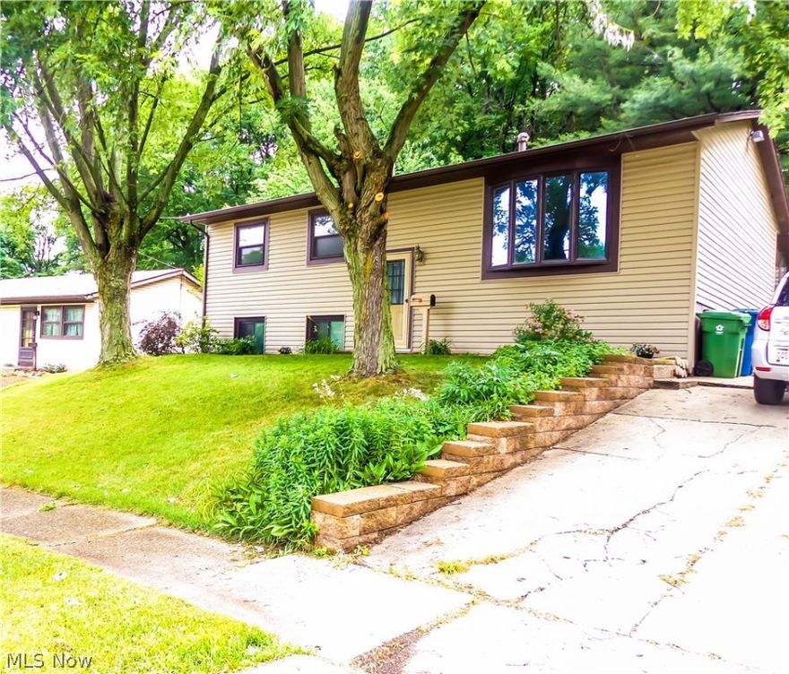 Welcome to Tallmadge! Come view this move in ready home. The living space in this home is much more than expected. Newly refinished hardwood floors throughout the living room, hallway and bedrooms. The home has new interior doors, baseboards and fresh paint on main level. The ceramic tiled bonus room on the lower level has a newer egress window for safety. The family room has new carpet and more than enough space for a family and office area. Both levels feature an updated full bath. The back of the home has a large four season room off the kitchen with new carpet. The backyard is private backed by a lovely wooded area. Huge storage barn for all your yard and gardening equipment. 
Call for a showing today.