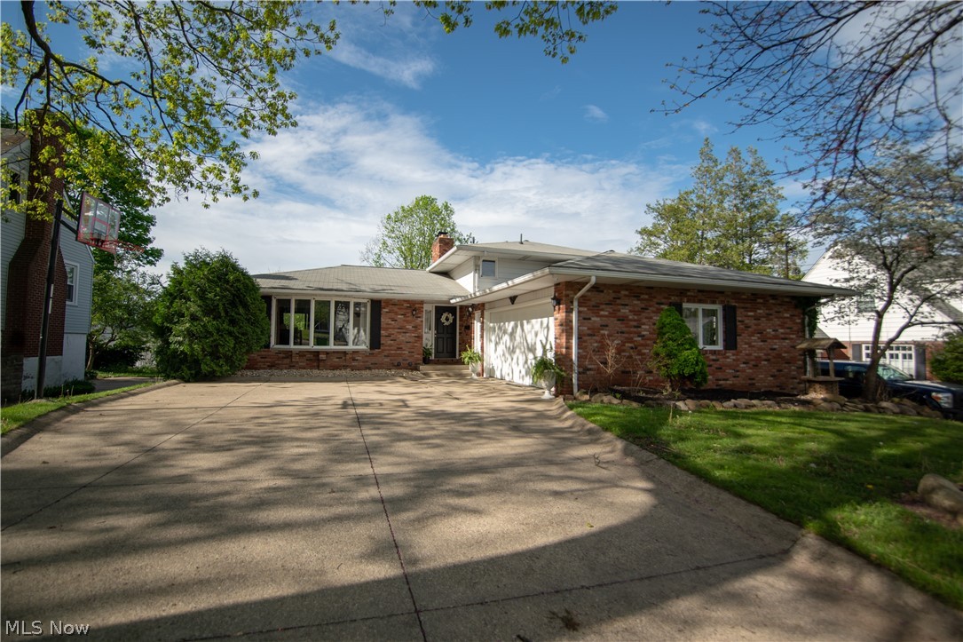 Come check out this beautifully remodeled split level home in Barberton! This home features fresh paint throughout the interior. As you walk inside, you will be amazed by the gorgeous renovated living room alongside the very spacious eat in kitchen featuring beautiful granite countertops. Upstairs on the second level features three bedrooms and one of the full baths with a dual sink. As you walk downstairs into the lower level, you will find the additional living room/media room which connects to the sunroom. The lower level with a second full bathroom contains an additional bonus room connected to the two car garage. But wait there's more! As you go down into the basement you will find a bar area that just needs your finishing touches and can be a great addition to hosting parties or entertaining guests. Come check out this very spacious split level today !