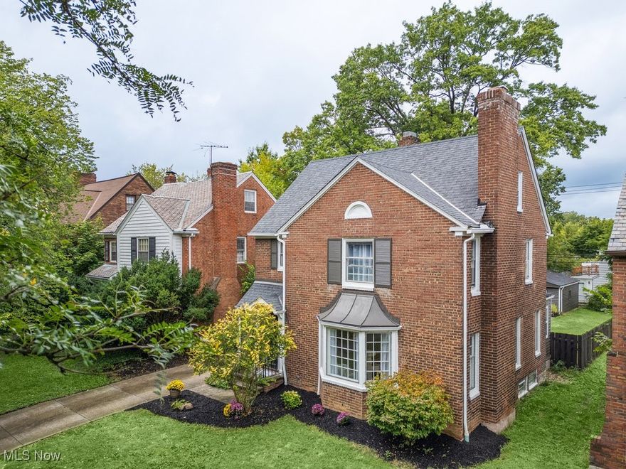 Welcome to this historic 4bed/4bath charming remodeled all-brick colonial home that perfectly blends its
original character with various modern updates throughout the entirety of the house. This
move in ready home features an open floor plan that floods the interiors with natural light,
creating a bright and welcoming ambiance. Upon entering, you are greeted with a stunning
beautiful wooden staircase. The first and second floors showcase gorgeous hardwood floors,
adding timeless sophistication throughout. The main floor layout flows beautifully including a
spacious living room with fireplace as well as a formal dining room with its lovely French doors.
The dining room seamlessly transition to a beautifully remodeled kitchen (2024) that is
equipped with quartz countertops, stainless steel appliances, and a spacious breakfast
bar—perfect for entertaining family and friends. Upstairs, the second level boasts two
bedrooms, including a master suite, both of which are complemented by stylishly updated
bathrooms (2024). There is a library which could become a third bedroom on this floor as well.
A private suite with a half bathroom is located on the third level offering additional comfort.
The lower level features a beautifully finished recreational room, ideal for leisure and
entertainment. Enjoy the covered patio outdoors connected off the detached two car garage.
Easy access to shopping and dining, just minutes from the Blue Line RTA for a quick commute to
downtown Cleveland and University Circle. Nestled on a quiet, tree-lined street in the desirable
neighborhood of Shaker Heights, this house is a must see!
