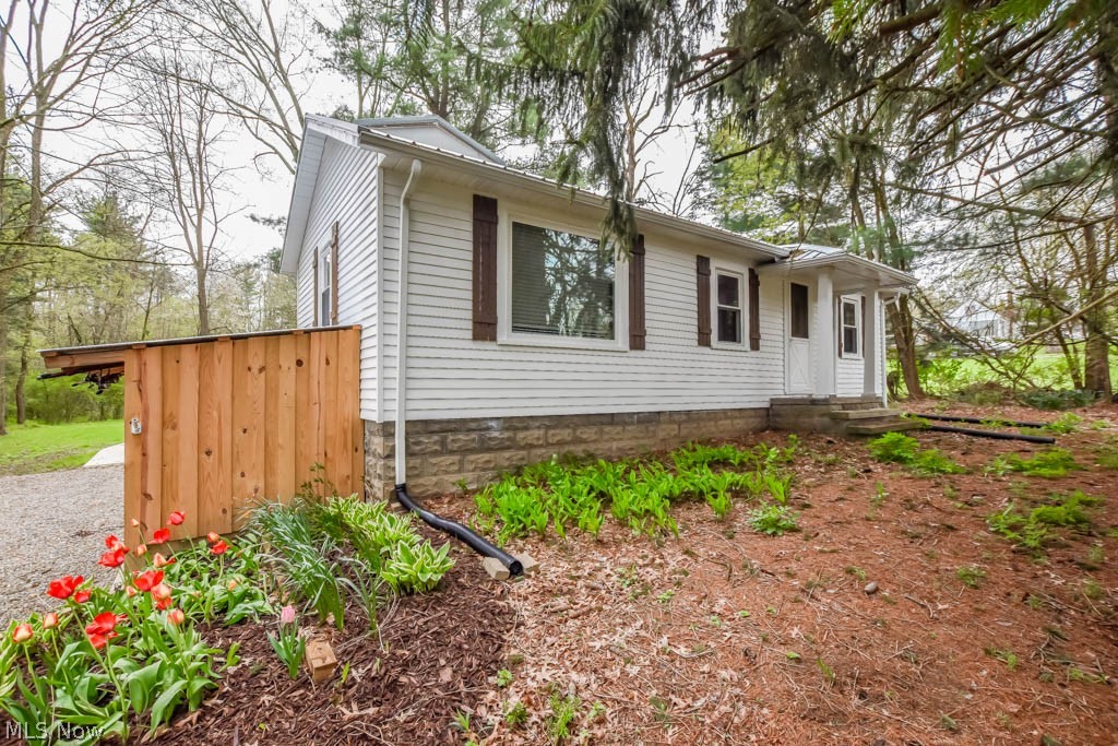 This picture perfect ranch has undergone a complete transformation, featuring notable upgrades such as a new roof, windows, furnace, A/C, septic system, well pump, hot water tank, electric panel, gutters with leaf guard, and more! Inside, farmhouse charm blends with a modern open concept, connecting the living room with a wood burner to the eat-in kitchen, boasting butcher block countertops, an apron front sink, range hood, floating shelves, and a pantry. A patio door opens to a brand new deck with a peaceful wooded view. The master suite offers a wood planked vaulted ceiling, private access to a covered porch, and a full bath with a beautifully tiled shower. On the other side of the house, the second bedroom features a private full bath with laundry facilities, along with a cozy loft space accented by rustic wood paneling. The full basement provides ample storage space and includes a walk-out to a convenient outdoor shower. Situated on over 5 acres of wooded land, the property also includes a new two car detached garage and storage shed. Your dream home awaits, call to see it today!