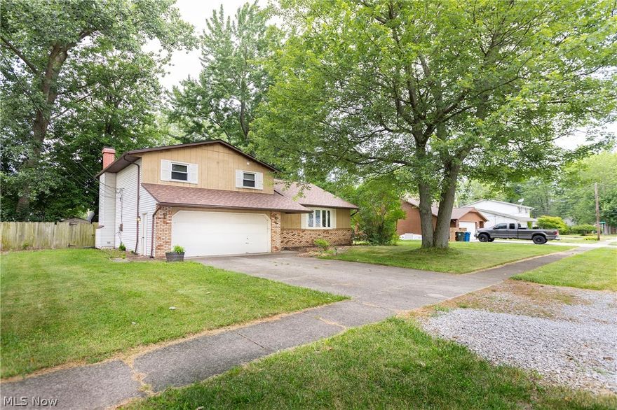 Welcome to this charming three-bedroom split-level home, situated on a peaceful dead-end street. The main floor features an inviting living room with a bow window that allows plenty of sunlight, an eat-in kitchen with ample countertop space and appliances that stay, a relaxing family room with a brick mantle fireplace, and a slider that opens to the backyard. A convenient half bath completes the main floor.

Upstairs, you'll find a sizable master bedroom with a large closet, two additional generously-sized bedrooms, a full bath and a hall linen closet. The unfinished basement offers a laundry area, a bonus shower, and plenty of storage space, providing endless possibilities.

The exterior of the home includes a two-car attached garage with an opener, a rear patio, and a fenced-in backyard, perfect for outdoor entertaining. Recent updates include a new roof with a transferrable warranty (2024) and a new hot water tank (2022), offering extra value and peace of mind.

This home is ready for your finishing touches. Call today to schedule your showing and make this charming Sheffield Lake property your own!