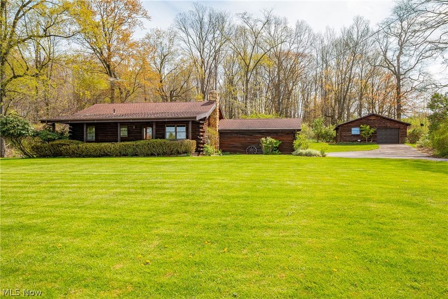 Beautiful custom-built log cabin home on 6.09 acres with 2 bedrooms and 1 bath. Looking for a peaceful cabin nestled away from the main road. A covered porch greets you as you enter your new home. Hardwood flooring, exposed wood beams throughout and open concept. The living room features an antique wood burner to give you that true rustic cabin feeling. Vaulted ceilings and a ceiling fan to keep you nice and cool. The kitchen and dining area offers plenty of counter space and a view overlooking the backyard. Down the hall is a full bath with large vanity. 2 generous sized bedrooms with closet space and ceiling fans. An attached garage with built in cabinet and stairs leading to the basement. A full basement with extra storage under the staircase. Outdoors you have a deck area just waiting for large gatherings. A detached garage perfect for storing all your yard equipment. You won’t want to miss this gem tucked away from the city but not in the middle of nowhere. Call today to make this your forever home.