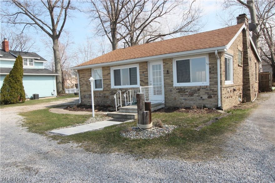 This is a great home at a great price if you are looking for Lake Front Property! This home has been completely remodeled new flooring, bathrooms, kitchen cabinets, Back splash, Stainless Steel Whirlpool Appliances, Ceiling Fans, Light Fixtures, Auto Mini Blinds,basement has been waterproofed 2017, Roof was replaced approx 5 yrs ago & also has newer windows. Home has an updated Kitchen that flows into the Dining Room w/new ceiling fan & sliders to the deck great location for grilling out. Large Bedroom off the Dining Room. Dining Room is open to the Spacious Living Room w/new ceiling fan, fireplace w/electric insert & great views of the lake. Living Room also has a open space off of it that would be perfect for a home office or sitting area that is right next to the front windows with lake views. The Laundry is on the first floor along w/a nice cedar closet. Full Bath off the Hallway & 2 Bedrooms, with 1 of the Bedrooms having a Full Bath. Everything is completely updated. The back yar