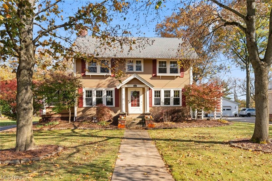 Welcome to this quaint 1914 colonial style home that is part of Wellington's history. A covered front doorstep brings you directly into the cozy main living space with a wood paneled fireplace & refinished oak hardwood flooring. An all season room is situated through french doors. The classic kitchen features stained wood cabinetry & woodwork, tile backsplash, new garbage disposal (2022) & 2020 dishwasher. The inviting formal dining room is perfect for an evening with family & offers ample storage with custom built-in cabinetry. Upstairs are the 3 carpeted bedrooms. The master has access to a fenced balcony that overlooks the large backyard. The full bath is also located on the second floor & has been completely renovated (2020). There is a full walk-up attic for added storage. Exterior features include a detached 3 car garage, shed, & small deck that leads to a concrete patio. Other updates include newer windows, updated electrical in the house & garage, roof in 2014, & new sump pump.