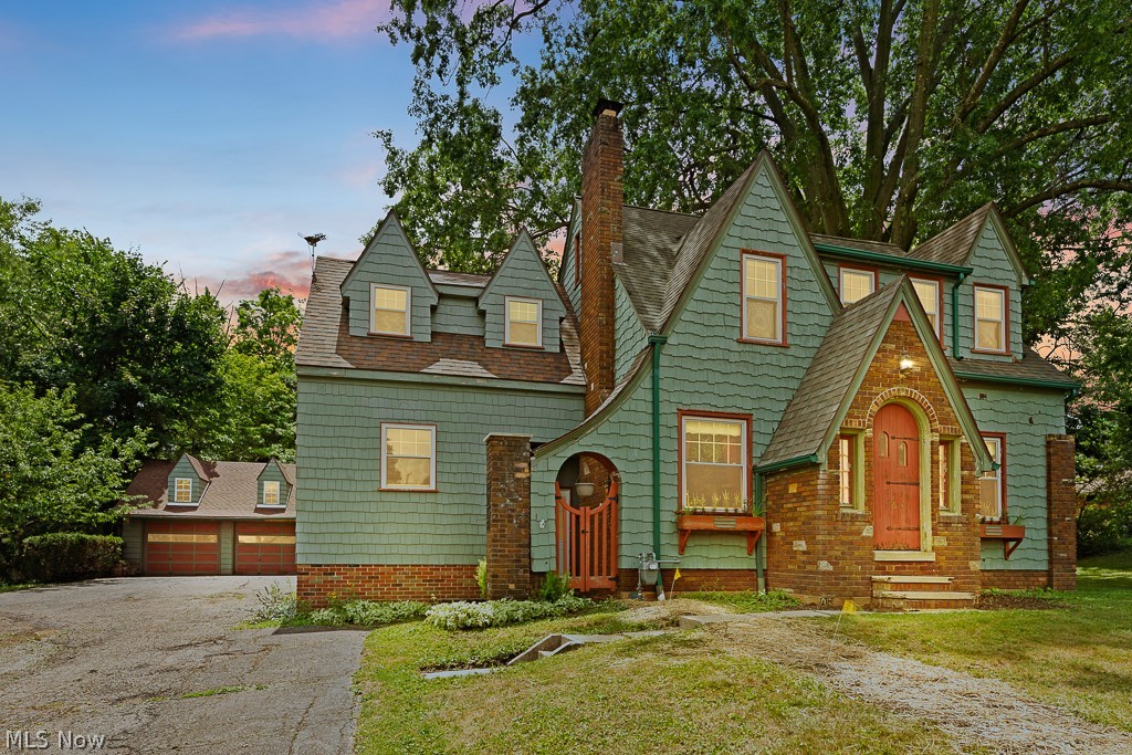 Welcome home to this fabulous Tudor home on a large lot in the heart of desirable Alliance! This unique gem features a fantastic addition, three huge bedrooms, a hobbyist's dream garage, and so many charming features, all on a serene, oasis-like lot. Enter through the front door into quaint foyer and into the spacious living room, featuring tasteful built-ins and a fireplace. From there, make your way through the dedicated dining room into the awesome breakfast nook/eat-in kitchen area! Featuring hardwood flooring, an abundance of cabinetry and counter space, complete with a bay window. A recently updated half-bathroom and super convenient first-floor laundry room complete the first floor. Make your way upstairs, where you'll find three humongous bedrooms, each with ample closet space. The master suite is a dream, featuring a half-bathroom and walk-in closet, together with built-in storage. The hallway features useful built-in storage space, and a full bathroom completes the upstairs. Downstairs, the large basement includes a great workshop area, plumbing for a half-bathroom, and an extra space courtesy of the new addition. Take the party outside where you will love to entertain on the large back deck that overlooks a park-like setting for your backyard. The oversized garage is a dream come true for the hobbyist, featuring a fireplace, finished attic space, and basement storage. Take the bridge to the second half of the backyard, featuring a wonderful entertaining patio, complete with it's own outdoor fireplace. If that wasn't enough, there is a second patio located behind the garage! Call today for your private showing, and don't miss out on this unique and charming Tudor home with fantastic outdoor entertaining space!
