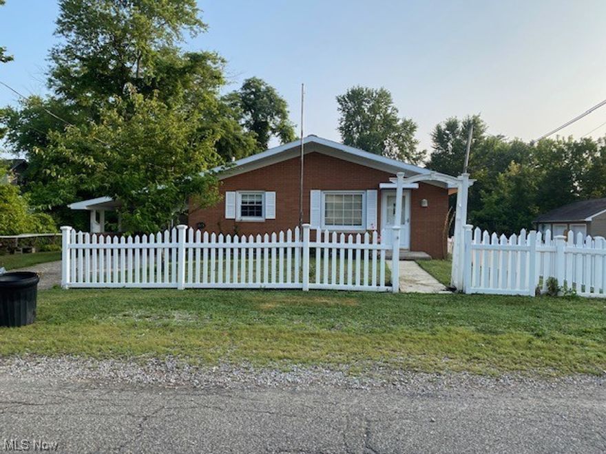 Many lots included in this one parcel. Fronts on Dearborn and Owens St. Darling 3 bedroom brick home plus several huge garages and outbuildings. Many options for the garages. 2 carports and outdoor patios. Small greenhouse. Enter pole building garage from Owens St.   Woodburner in garage.  Too many features to mention .Bathrooms are updated in home. Solid brick home and garage. Basement has small efficiency with walkout door.   Outstanding property.  Hard to find another one like it!!!!  Soo many features.  Better look fast!  Nice clean property.  Ready for you to move into..Possession at closing.