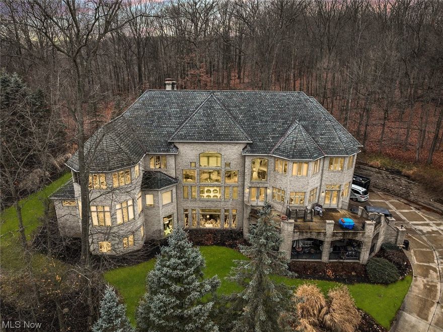 Luxurious  Estate! Custom Fully brick with Soaring ceilings  Extensive qualities and  finest materials including marble & limestone flooring plus 8' solid core doors.Welcoming 2 story foyer with 2 custom Wrought Iron Staircases leads to a Stunning  Great Room with wall of windows, trayed ceiling, custom built-ins & see-through fireplace.Gourmet kitchen with all the amenities: custom cabinetry, granite & marble. Large dinette area with doors to outdoor veranda.Formal dining room with trayed ceiling & crown molding, plus Butler's Pantry with granite & sink & wine refrigerator.Lux 1st floor master suite with trayed ceiling, fireplace & wall of windows. 2 bathrooms, Spa-like glamour bath with jacuzzi tub & custom tiled shower with multiple shower heads. 2 large walk in closets 3 Floor Elevator. beautiful Sunroom 24x16, 2 floor large loft area, 3 bedrooms 3 full Baths.  Finished Walkout basement with great room with fireplace,  home office with private door or 6th bedroom full bath playroom storage area, Large Custom Patios, Verandas, Arched Entryway.  $4 car garage. On a  Private 1.60 acre lot,peaceful park like setting with great views. Great value!!!! Can not duplicate for the price!!! Prime location  Near all conveniences, I-77 & Turnpike I- 80. Award winning school system. Access to Brecksville Community Center, 64,000 sq ft state-of-the-art recreation facility includes indoor & outdoor pools, fitness center!!!