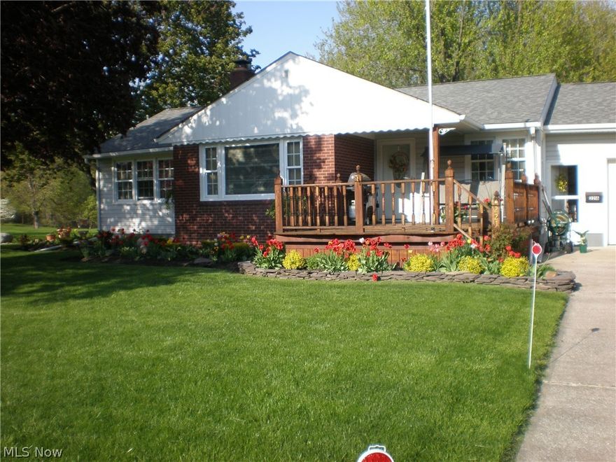 Wow...don't do a thing...just move right in! Meticulous Ranch with large 2+ attached garage with rear garage door. Remodeled kitchen with island and bar stools, pantry and  under counter lighting. Formal Dining room; Open living room with cathedral ceiling, built-in oak shelves and crown molding and wood burning fireplace. Gorgeous new bathroom with marble floors, granite sink and lots of extras!!! Full basement that has a full bath in room where washer and dryer used to be (hook ups still there)...moved them upstairs and put hook ups in 3rd bedroom. Basement has walkout and lots of storage. Two partitioned rooms that could easily be finished off and used as extra rooms. Security system with Vector Security $29.80 per month with battery backup. Now let's talk about the yard...total of 6 lots...professionally landscaped with rock garden; trellis; patio and swing...all of this in a park-like setting with E. 22nd (paper street) on the north and back of property which has with trees and wo