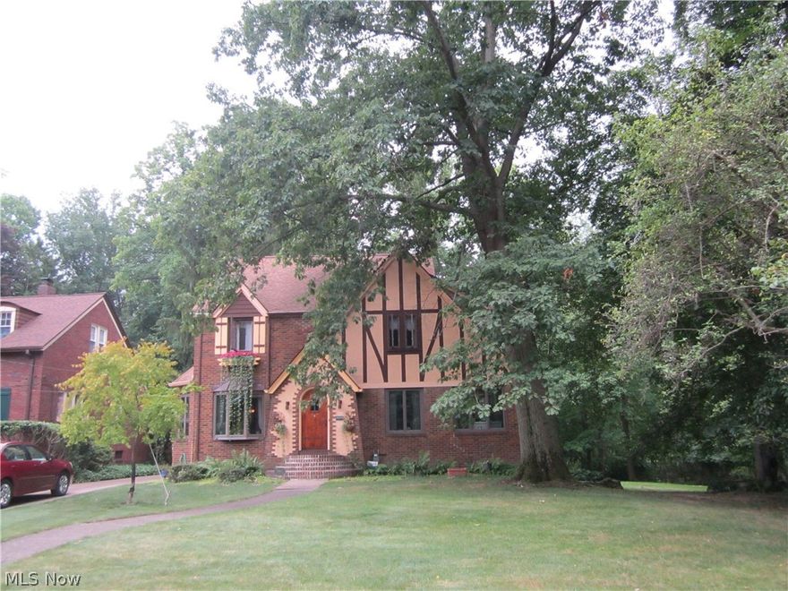 Welcome to the lovely area of Evergreen Lake. This Brick Tudor home has always been lovingly cared for. Walk into the gracious living room with fireplace, spacious dining room with gorgeous windows and a Sun Room which can also be used as a Family Room.  Flooring throughout the house is hardwood.  The kitchen has lovely newer cabinetry and Corian countertops and flooring.  The Master Bedroom is very spacious and the other 2 bedrooms are nice sized. The 3rd floor is finished and has been used as an office for many years. Replacement windows throughout the home, except for the attic.  At the rear of the home is a beautiful brick covered porch and brick patio.  Please note that is is a 2-parcel property..the side property is 55x555 and is Grandfathered-in as a buildable lot.  The home itself sits on an approximately 55x181 lot.  The double yard is exquisite and restful.