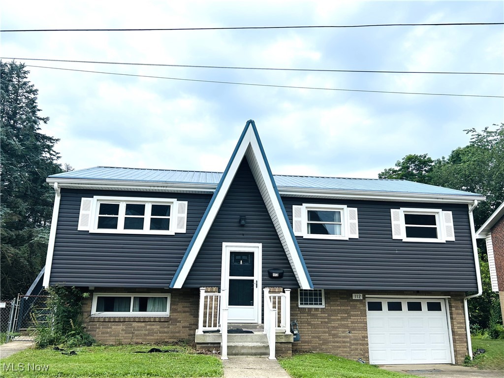 Welcome to this charming 3-bedroom 1-bath bi-level home nestled in Marland Heights neighborhood. You'll love the updates that have already been completed for you, including an updated bathroom with a walk-in shower, newer flooring in the kitchen, living room and hallway plus updated siding, windows, soffit, shutters, downspouts, and roof! Downstairs the partially finished 22x12 sq ft space offers endless potential-whether you envision a cozy rec room, family room, creative studio, the choice is yours! A workshop area in the basement is perfect for hobbies or DIY projects. Stay dry year-round with the attached 1-car garage featuring a new garage door and opener. Step outside to relax or entertain on the 2-tiered deck overlooking the fenced-in backyard-ideal for pets, kids. or quiet evenings. Call today to schedule your showing.