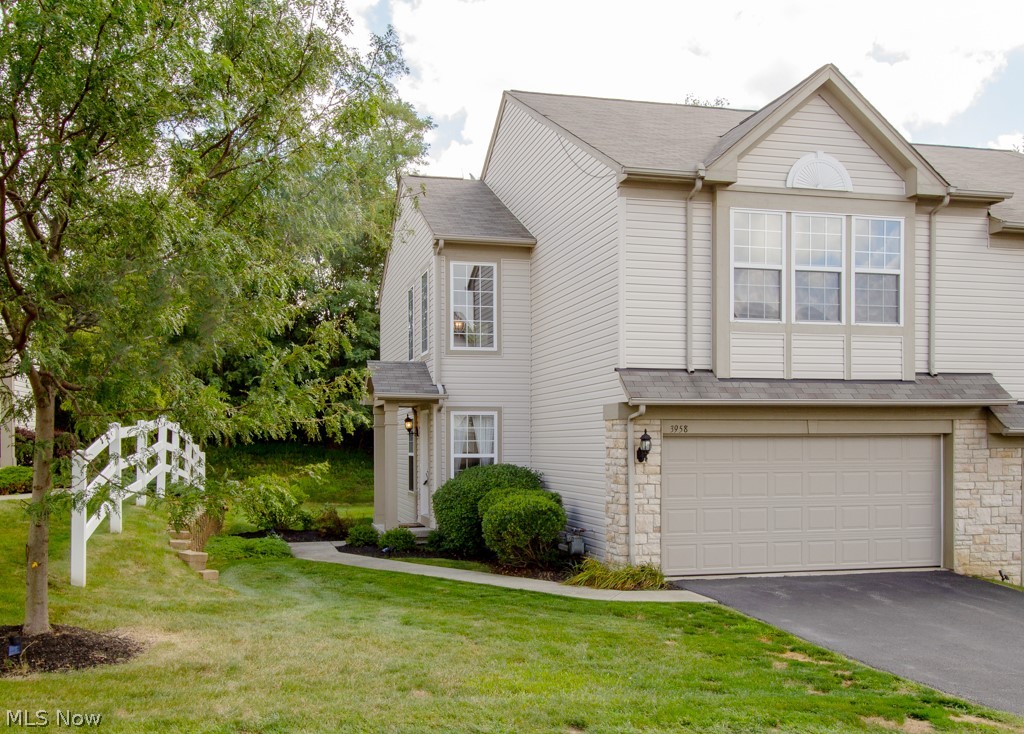This lovely end unit, has a bright, open floor plan with a two-story foyer. The kitchen features a breakfast bar, maple cabinetry, stainless steel appliances and newer granite counters with professionally tiled back splash. A walk-in pantry provides ample kitchen storage space. Completing the main level is a conveniently located half bath. The loft, overlooking the foyer and family room, is ideal for an additional entertainment area, office or children's play area. The large master bedroom has a tastefully updated en-suite bathroom and walk-in closet. There is a second bedroom on the upper level, and the second full bathroom on the upper level has also been updated with granite counter tops, under mount sinks and new fixtures. The conveniently located second floor laundry room has a charming barn door access. Additionally, the new garage doors are fully insulated, and the home's heating and cooling is controlled by a Smart Thermostat. Move-in ready, and beautifully maintained, this