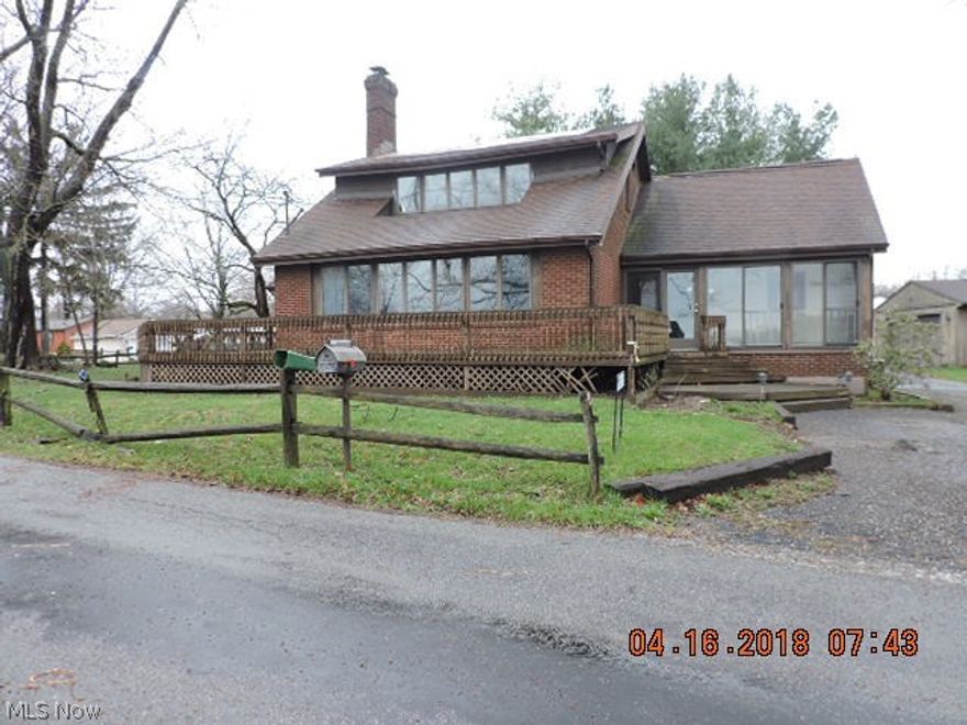 NORTH RESERVOIR.  Not quite lake front but almost as good!  This contemporary inside - mostly traditional brick cape outside - has 4 parcels of land.  It sits on .47 acres and has a 4th parcel with 144 feet of lake frontage directly across the narrow very private street. The inside needs a lot of updating, but you won't be disappointed with the spacious fireplaced great room and the view from the 1st floor master bedroom, deck, and enclosed front porch!  The loft could be a 4th bedroom but it certainly is flexible space - maybe a family room?  There's also a HUGE basement rec room that needs to be refinished.  There are 3 sump pump openings, a boiler, a newer looking water tank, and a very new large electric panel.  The heat is zoned hot water baseboard and the air conditioning is a combination of central air and bedroom in-wall units.  Buyer MUST have a well and septic inspection in Summit County.  These are for buyer information and they do not have to pass code in order for the coun