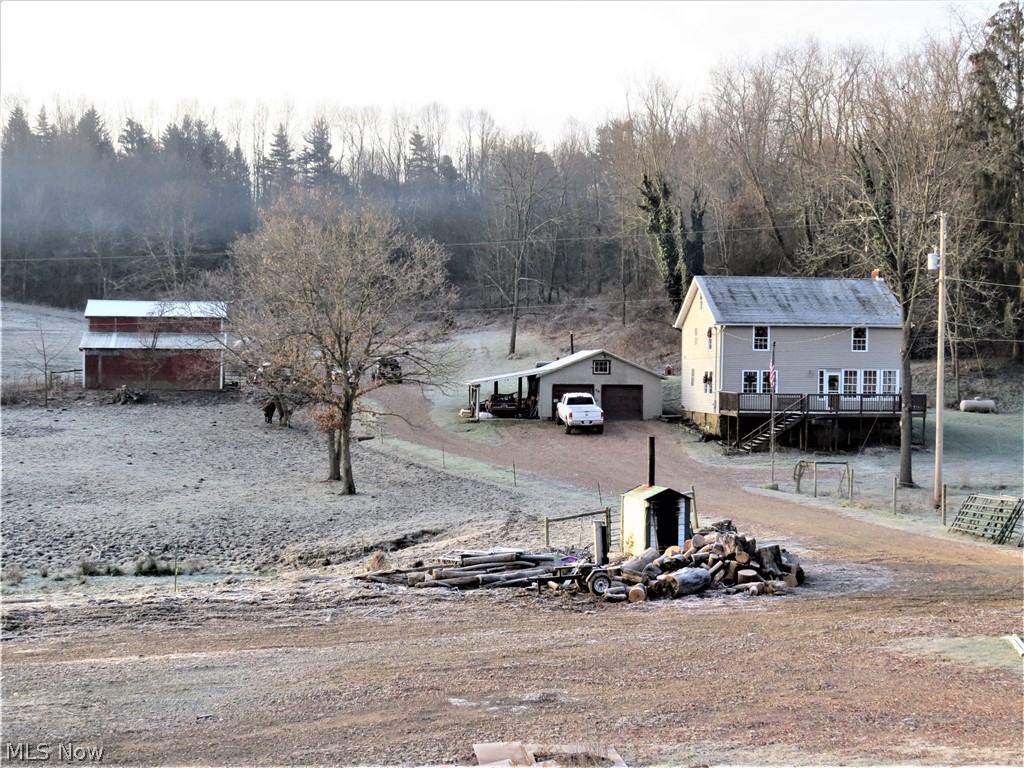 Renovated Farmhouse with Barn, Garage, and 40x60 Steel Bldg on 11.7 Acres! Totally renovated 2 story farmhouse in 2009 features oak kitchen with island, stone fireplace in living room, wide oak staircase with reclaimed timber posts, huge bedrooms with wood floors, 2nd floor laundry room, and walk-up attic that could easily be finished to add an additional 300 + sq. ft. of living space. There's a full walkout basement, and large wooden deck off the enclosed front porch. The home was gutted to the studs and insulated, wired, plumbed, and new interior and exterior in 2009. The property features 4 fenced pasture paddocks and the 32x40 barn with loft, has water. The 3-car detached garage has electric and door opener. The 2017 40x60 steel bldg has 20 ft. sidewalls and 14x16 ft doors at each end. This bldg has 6-inch floor with radiant heat, 3 Phase Electric, LED lighting, and JIB crane. This bldg is heated by outdoor wood furnace that heats the home as well. Bldg has good access to the state