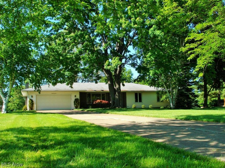 What a wonderful ranch home situated on a rare one acre beautiful treed lot.  This 3 bedroom home has been well cared for, recently updated and ready to move in and enjoy.  Entering into the home you will find a spacious living room area that leads you into an open family room with accompanying bright and open 3 season room.  The focal point of the family room is its floor to ceiling wood burning fireplace.  Stepping up into the large remodeled eat-in kitchen with new flooring, countertops and some appliances – you have plenty of light from large windows overlooking the expansive backyard.  All bedrooms boast polished gleaming hardwood floors accompanied with a tastefully updated bath.  The full basement area has a workbench or craft area and a large room that can be completed for additional living.  Enjoy summer activities in your stunning yard or enjoy the city’s local park across the street.  With new carpet, flooring and paint; this amazing home is ready for your special touches.