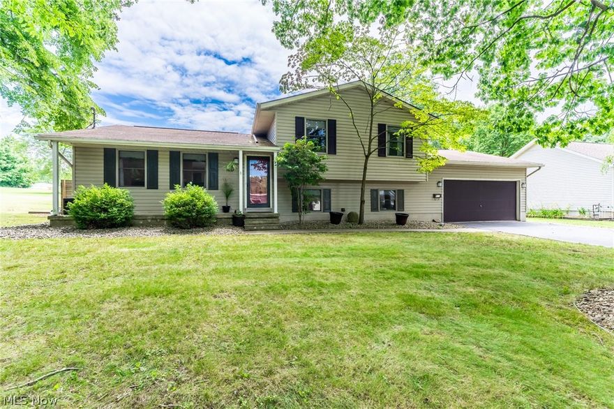 Don't pass up this opportunity to have your perfect house on a double city lot with plenty of room to grow! This beautiful split level offers tons of updates so you can move right in without worries! As you walk in the openness of the house, you are greeted with vaulted ceilings, dark bamboo hand scraped flooring, porcelain tile, an enormous kitchen with tons of cabinet space, updated stainless appliances, fiberglass back splash, solid surface counter tops and recessed lighting throughout! The family room offers a great space to entertain near the white brick fireplace or at the custom built bar with a black walnut bar top. 3 Bedrooms upstairs with great closet space in each room and an updated bathroom with a double sink granite top vanity! First floor laundry with another full bathroom with a marble top vanity. Another additional area that could be finished in the basement with tons of storage. 2 car attached garage. Off the eat in kitchen, great two tiered deck with a 8 person hot t