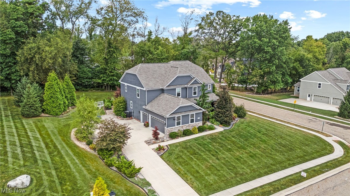 This well-appointed home offers an inviting blend of elegance and comfort, showcasing numerous custom features throughout. Nestled in the desirable Emerald Estates of Jackson Township, this 5-bedroom, 4.5-bath residence is ideal for both everyday living and entertaining. Step inside to a spacious open-concept design featuring a welcoming foyer, chef’s kitchen with custom hickory cabinetry, hidden design elements, a large island, and a charming built-in booth. The kitchen flows seamlessly into the family room with its warm stone gas fireplace and an all-season room overlooking the private, cottage-style backyard. Enjoy quiet mornings on the covered patio, the perfect spot for coffee or relaxation. The second floor hosts four generously sized bedrooms, 3 full bathrooms, a convenient laundry room, and a step-up bonus room offering flexible living space. The finished lower level extends the home’s versatility with a large recreation room, additional bedroom, and full bath. With thoughtful craftsmanship and cozy touches throughout, this home is a must-see. Schedule your private showing today!