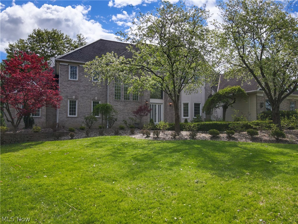 Walk in and fall in love with your new home! Discover this exquisite custom-built, single-family home sprawled across a lush one-acre parcel in Chagrin Highlands. Step into the grandeur of a two-story foyer, setting the tone for this impeccably maintained residence. A breathtaking family room, adorned with a wall of windows, floods with natural light, and is complemented by a striking fireplace. The kitchen, with sleek euro-style cabinets, granite countertops, and premium appliances, boasts a breakfast bar and a cozy informal dining area, surrounded by panoramic views. Host formal gatherings in the elegant dining room or retreat to the impressive library, complete with gorgeous shelving and cabinets. Unwind in the opulent first-floor primary suite, featuring a lavish bathroom and a spacious walk-in closet. Completing the main level is a stylish half bath and a convenient laundry room. Ascend to the second floor via one of the dual staircases to find two bedrooms sharing a bath, alongside a bedroom with an ensuite full bath. Entertain in style in the expansive lower level, offering an entertainment area, game table space, and a relaxed sitting area. Stay active in the exercise area, complete with a sauna and a full bath. Outside, revel in outdoor entertainment with the convenience of an outdoor kitchen area, complete with a grill, sink, and refrigerator, set upon generous stone patios. This remarkable abode also features a three-car garage with individual openers and a whole-house Generac generator, ensuring comfort and convenience. Don't miss the chance …. it's the perfect haven for one fortunate family!