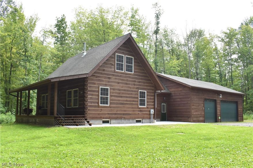 Log Home on nearly 20 wooded Acres! This private setting is the perfect get-away retreat for hunters, fisherman, outdoors enthusiasts, or anyone looking for a peaceful setting in the woods!  Enjoy evenings on the covered porch overlooking wooded trails & catch a glimpse at local wildlife including deer & turkey right in your backyard! The cabin boasts vaulted ceilings with an open layout and a large loft that could be used as a second bedroom or bunk area. Features include 1 first floor bedroom, first floor laundry & bathroom, and a mudroom that leads to a 40'x30' garage with 3 10' overhead bays in the front & 1 opening to the backyard. The garage also has electric, water, & floor drains. Full basement with radiant heat in the floor & a walk out stairway to the backyard. The entire home was just treated and re-stained this year. Floors are left unfinished so you can pick whatever floor coverings you prefer! Located in Ashtabula County centrally between Lake Erie & Pymatuning Lake, and