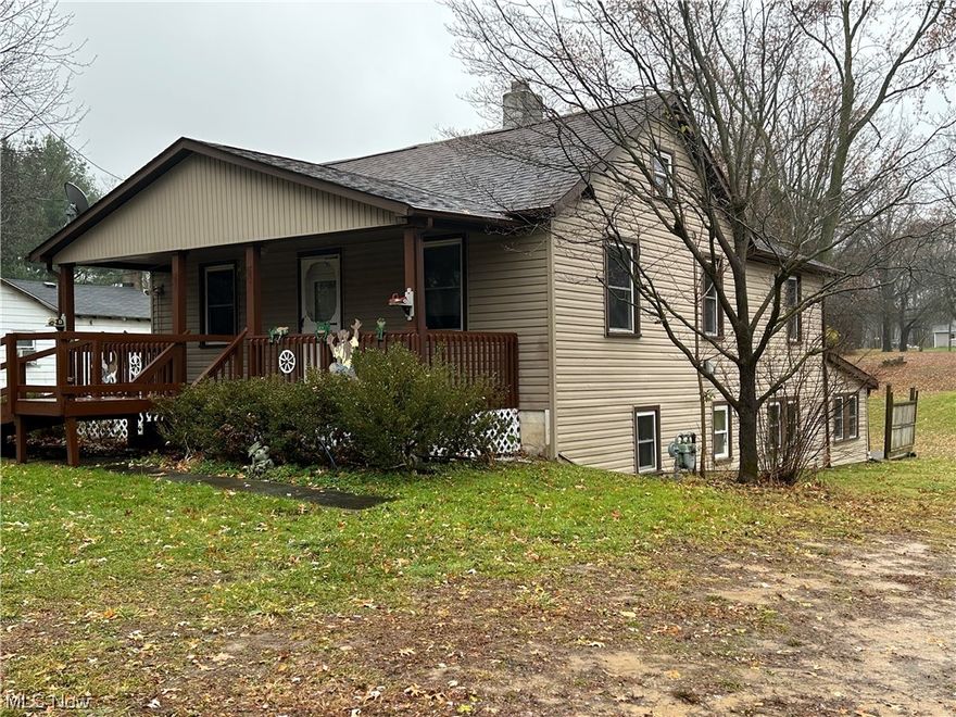 Your family has been waiting for this home.  With a true walk-out basement, both floors total 2576 square feet with 4 bedrooms, 3 full baths, 2 garages all on   L-shaped 1.5 Acres in Springfield Twp near the Mogadore line.  Room for family and friends camping out and backyard winter sled-riding hill, both an easy view from either enclosed sunroom.  Separate bedrooms on both floors for nice privacy.  The attic could be transformed into an inside child's playhouse.  Large main- floor master, nice size closets, useful built-ins, most vinyl tilt-in windows, fruit cellar for the gardener, and a large all brick fireplace are nice features.  Well water, city sewer, gas heat and central air.  Updated 200 amp electrical box with a separate meter for the big red workshop garage.  With separate entrances, this home could easily serve as a two unit; plenty of spaces for all ages and sizes of family.  Back road just behind big red garage is yours also; an easement in place for the two small private resident owners in back.   A fun opportunity to redecorate your way.  Isn't it time to get out of the city?  Immediate possession upon title transfer. City sewer well is 95' deep.