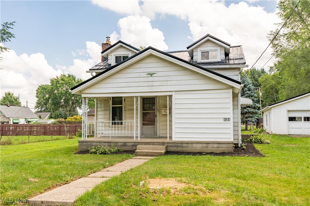 Welcome to this beautifully updated bungalow, offering over 1,000 sq. ft. of bright and inviting living space on an oversized lot. A covered front porch welcomes you inside, where the sun-filled living room features under-stair storage and flows seamlessly into the formal dining room. Warm wood paneling adds a cozy touch, and access to the covered back patio, perfect for outdoor dining or relaxing by the fire pit in the backyard. The updated eat-in kitchen is both functional and stylish, featuring white cabinetry, a classic subway tile backsplash, and peaceful views of the backyard. The main-floor primary bedroom offers two closets and a private full bath with a tub/shower combo and a linen closet for extra storage. Upstairs, you’ll find 2 bedrooms, along with a second full bath. The unfinished basement offers a shower, sink, laundry area, and plenty of room for storage or a future workshop. A detached 2-car garage with a built-in workbench completes this fantastic home. Recent updates include a metal roof, toilets, vanities, kitchen cabinets, windows, furnace, AC, hot water tank, fresh paint, new garage door opener, and updated plumbing. Don’t miss your chance—schedule your private showing today!