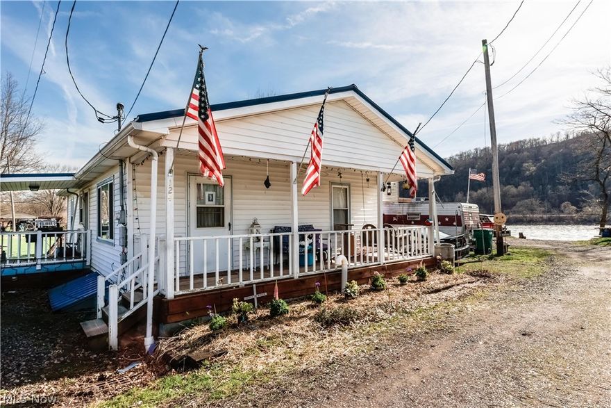 This beautiful move-in ready home offers one story living in an open airy floor plan. Sit on the front porch and enjoy the river view. Perfect for fishing and water sports. There is a ramp to the back door for wheel chair accessibility. Convenient to the grocery store and shopping.  All you have to do is move in and start living, all at a price less than most rent!

The price has dropped, but the cabin does not go with the property.  The home does come with two sheds. There is a partial basement for extra storage. It has been used as a workout room by the current owner.  Many updates to the home including a newer roof.